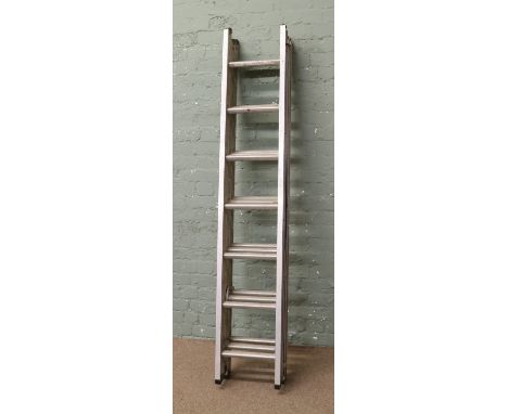 A triple extending aluminium ladder.