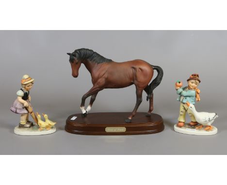 A Royal Doulton bisque model of a bay horse 'Spirit of Youth' and two Friedel Hummel style figures.
