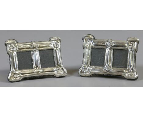 A pair of Art Nouveau style sterling silver miniature twin photograph frames.