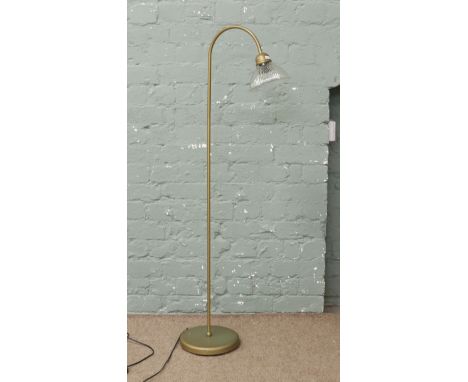A painted tubular steel standard reading lamp with reeded clear glass shade.