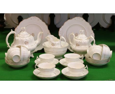 A Regency porcelain 12 place teaset with gilt decoration and incorporating a tea pot, sucrier and milk jug.