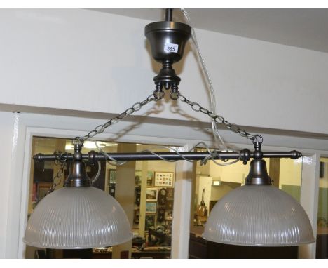 An adjustable twin branch light fitting with reeded clear glass shades.