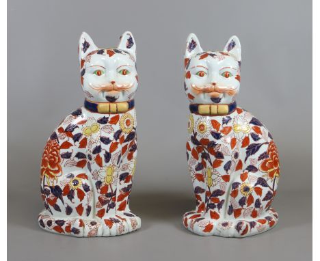 A pair of Japanese Imari large painted ceramic fireside models of cats.