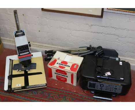 A Durst M600 photographic enlarger along with a Gama 74 tripod, Bogen easel, a boxed Hanimex projector and a Kodak ESP Office