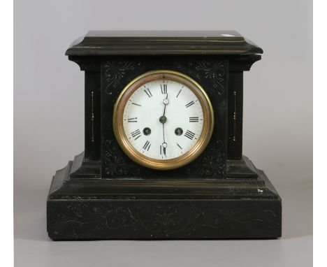 A Victorian slate mantel clock with enamel dial, housing a French 8 day cylinder movement striking on a bell.