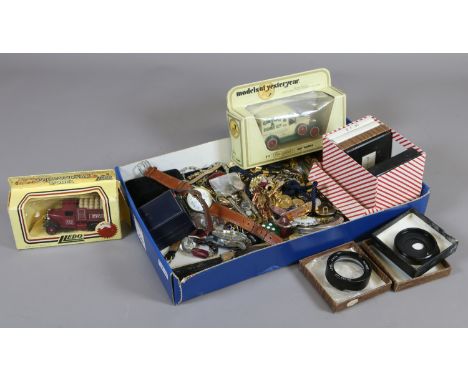 A box of mixed collectables including enamel pin badges, costume jewellery, wristwatches, boxed Diecast model cars, vintage p