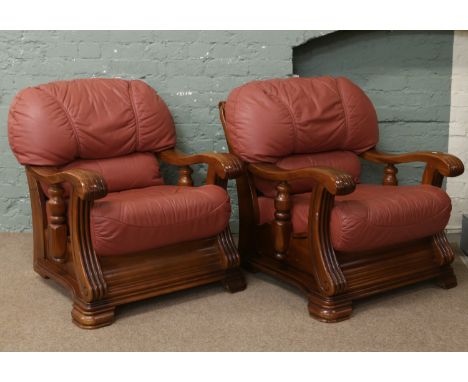 A leather three piece suite with carved oak frame raised on bracket supports.