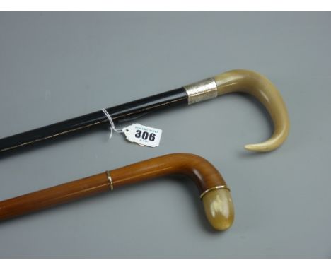 A gent's walnut topped cane with cabouchon horn tip and yellow metal ring mounts, 92 cms and an ebonized cane with steamed ho