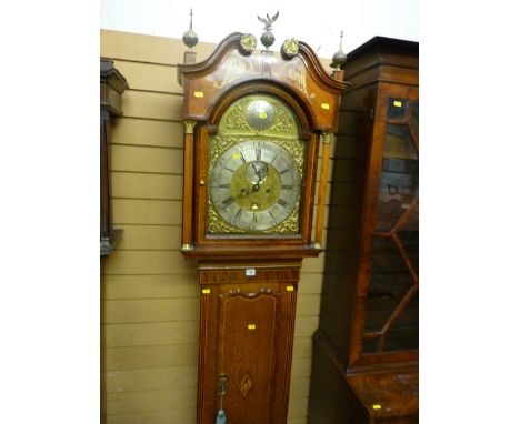 A fine quality oak and mahogany inlaid longcase clock having an arched hood with brass and scrolled pediments, inlaid panels 