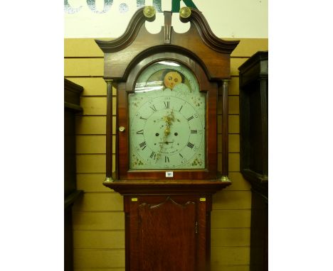 An early 19th Century oak and mahogany longcase clock, the hood with broken swan neck pediment, arched top glass door with fl