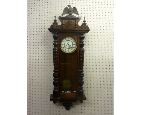 A 19th Century Gustav Becker walnut cased Vienna type regulator, twin weight with painted enamel dial, carved pediment with t
