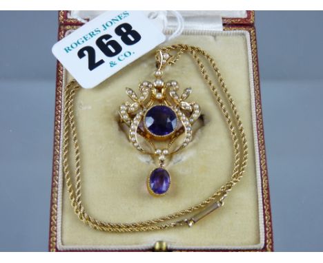 A fifteen carat gold amethyst and seed pearl pendant brooch having a centre round cut amethyst of estimated 4 carats and an o