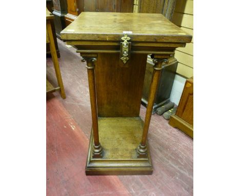 An oak side stand with square top and brass ring embellishment above a chamfered frieze supported by turned carved columns, s