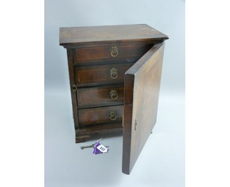 A possibly Italian walnut and burr walnut single door table cabinet with line strung inlay, the locking door opening to revea