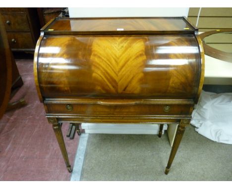 A reproduction crossbanded mahogany lady's cylinder bureau with slide-out red gilt tooled work surface and interior compartme