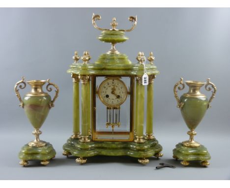 A French onyx and gilt metal clock garniture set with good shaped base, six pillared temple style clock case with urn finial,