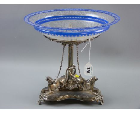 An electroplate table centrepiece on tri-form base, each edge with a figure of a tethered hound, their tails entwined around 