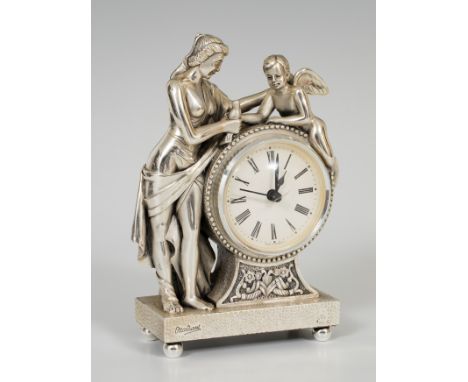 OTTAVIANI table clock in sterling silver. Second half of the twentieth century. Depicting a lady and an angel following class