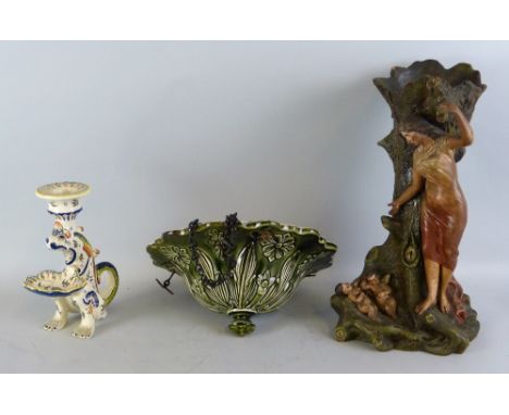 A 19th century French glazed terracotta vase, as a lady standing beside an open tree trunk with two winged cherubs sleeping o