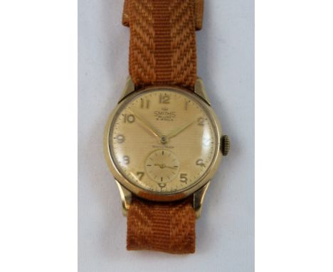 Smiths de lux - a 9 ct gold manual wind presentation wristwatch, Edinburgh 1961, the beige dial with gilt Arabic numerals and