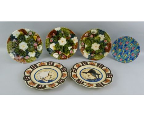 A set of three French majolica plates, each moulded with fruiting strawberry plants 22cm diameter, a pair of Quimper France p