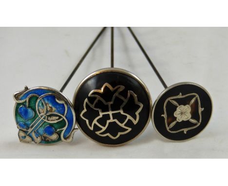 An Art Nouveau silver and enamel hat pin, Birmingham 1909, a silver and tortoiseshell hat pin, Birmingham 1913 and another Lo