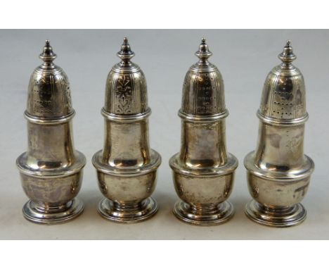 An Edwardian silver set of four castors, Sheffield 1908, of baluster form with vase finials, initialled R, height 15 cm, weig