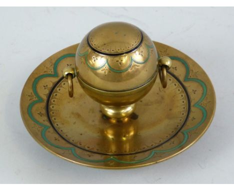 A Victorian brass desk stand, retailed by Houghton and Gunn (later Asprey), with two-handled central globular ink well on a d