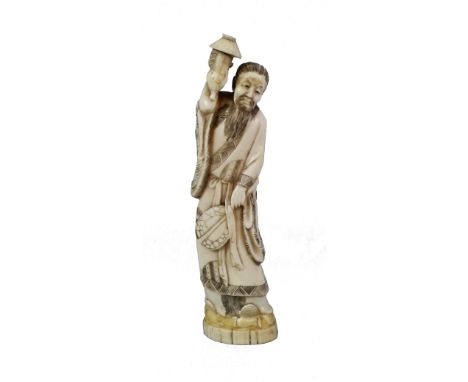 A Japanese Meiji period ivory okimono, carved from the solid as a man holding a gourd shaped lamp (?) above his head and a fa