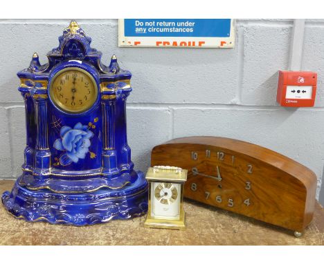 An Art Deco walnut mantel clock, a Hermle quartz carriage clock and a ceramic cased clock with separate stand, (3) 