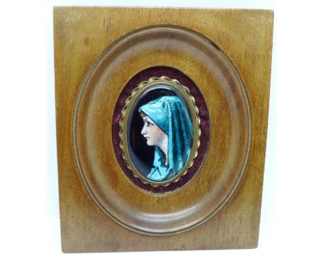 A framed oval enamel plaque of St Fabiola