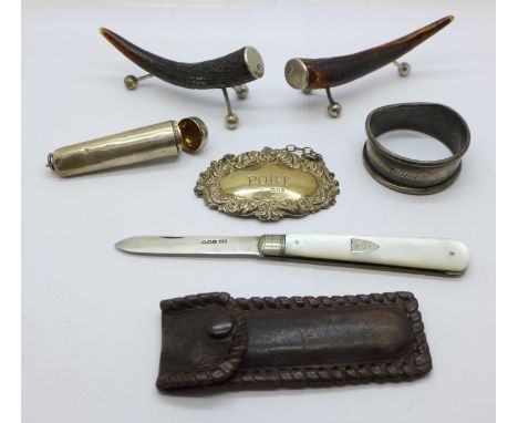 A pair of silver mounted antler knife rests, a silver Port label, a silver napkin ring, a/f, a silver cheroot holder case and