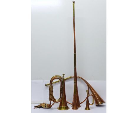 A brass and copper bugle and four brass and copper horns including hunting 