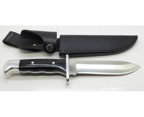 An American Buck 124 hunting knife with leather scabbard 