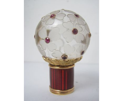 Karl Faberge - a carved rock crystal cane handle carved with flowers and collet set with rubies over a gold collar and red gu
