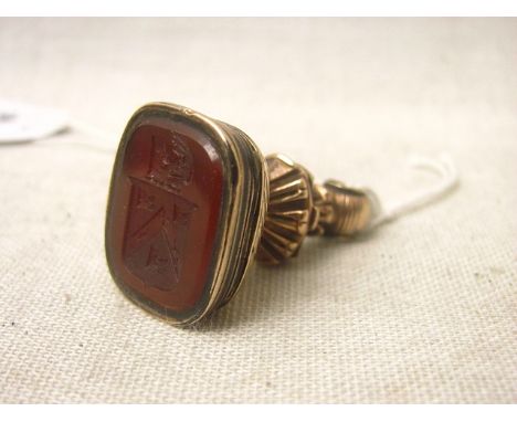 A Georgian gold coloured metal in memoriam fob seal with hinged top revealing a glazed compartment containing woven hair, the