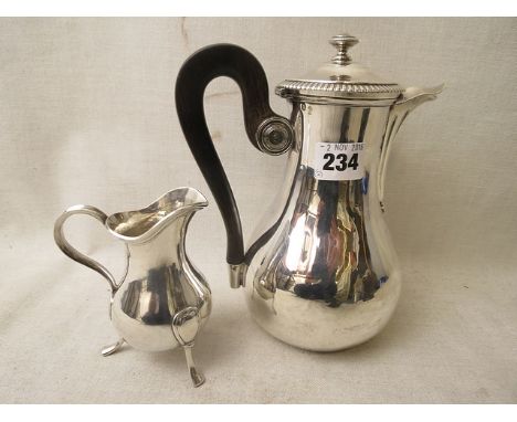 A 19th century French silver coffee pot in the Empire style, of bulbous form with ebonized handle and button finial, along wi