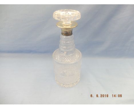 A cut glass decanter with hallmarked sterling silver collar A/F