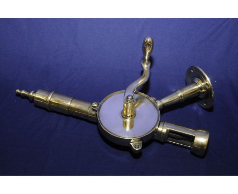 Early 20th C polished brass bar mounted corkscrew with winding action (41cm high)