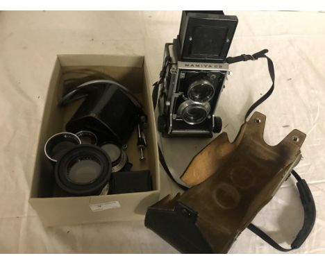 A Mamiya C3 TLR camera with two additional lenses