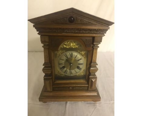 An Edwardian carved mahogany day movement mantel clock