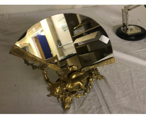 A gilded bronze cherub mirror