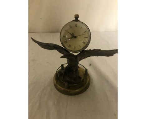A bronze clock in the form of a flying eagle