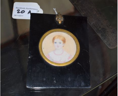 English School (19th century), a portrait miniature, of a young girl, watercolour on ivory, circular, 5.5cm diam