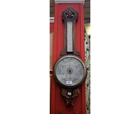 An Edwardian oak cased aneroid barometer