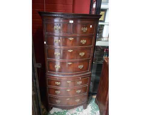 A reproduction mahogany bow front chest on chest, two short drawers over three graduated drawers to top, slide and three grad