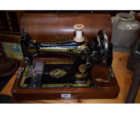 A vintage Singer hand operated sewing machine, cased