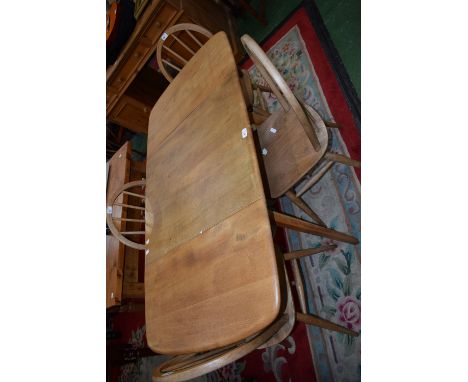An Ercol dropleaf table and a set of four Ercol style stick back kitchen chairs 