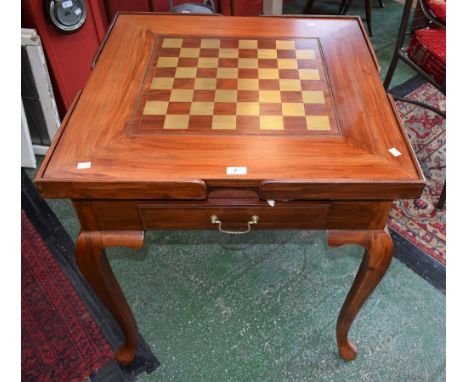 A modern hardwood games compendium table with brass inlaid playing board and brass stringing, ceramic chess pieces, etc.