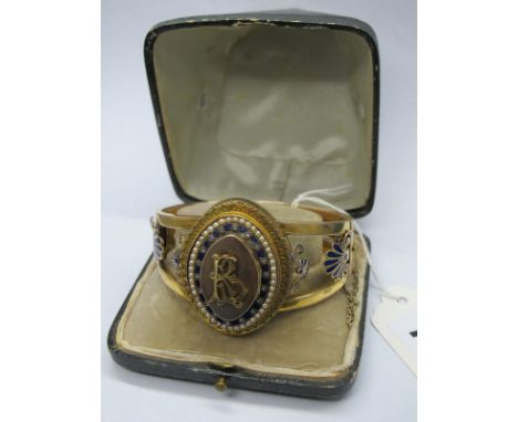 A XIX Century Bangle, detailed to the front with a stepped oval panel, initialled, between tapering openwork shoulders, highl